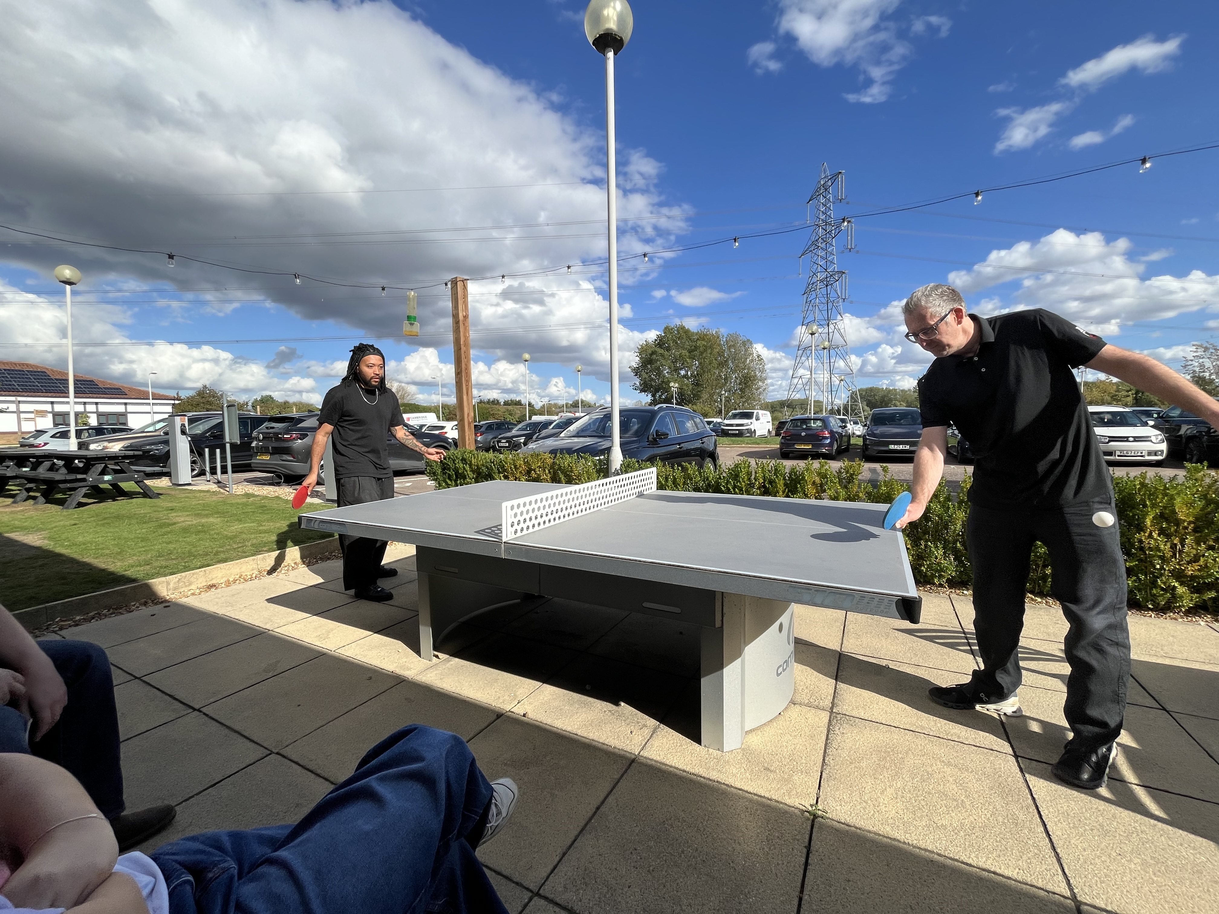 Table tennis match by car park at Wyboston Lakes resort