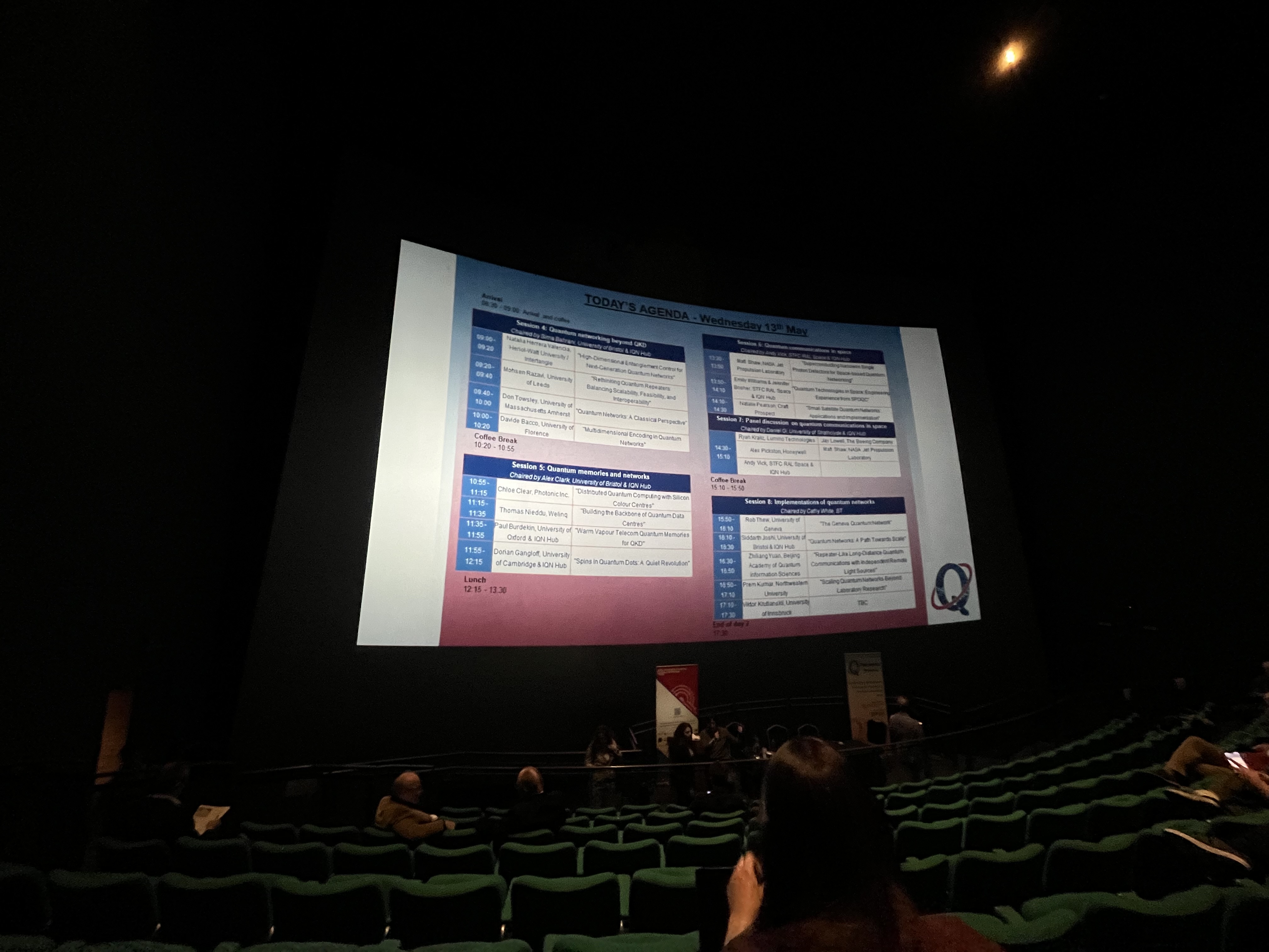 Day agenda for conference on IMAX screen